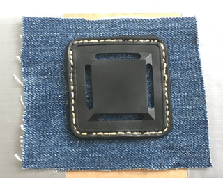 lash tab sewn to denim,